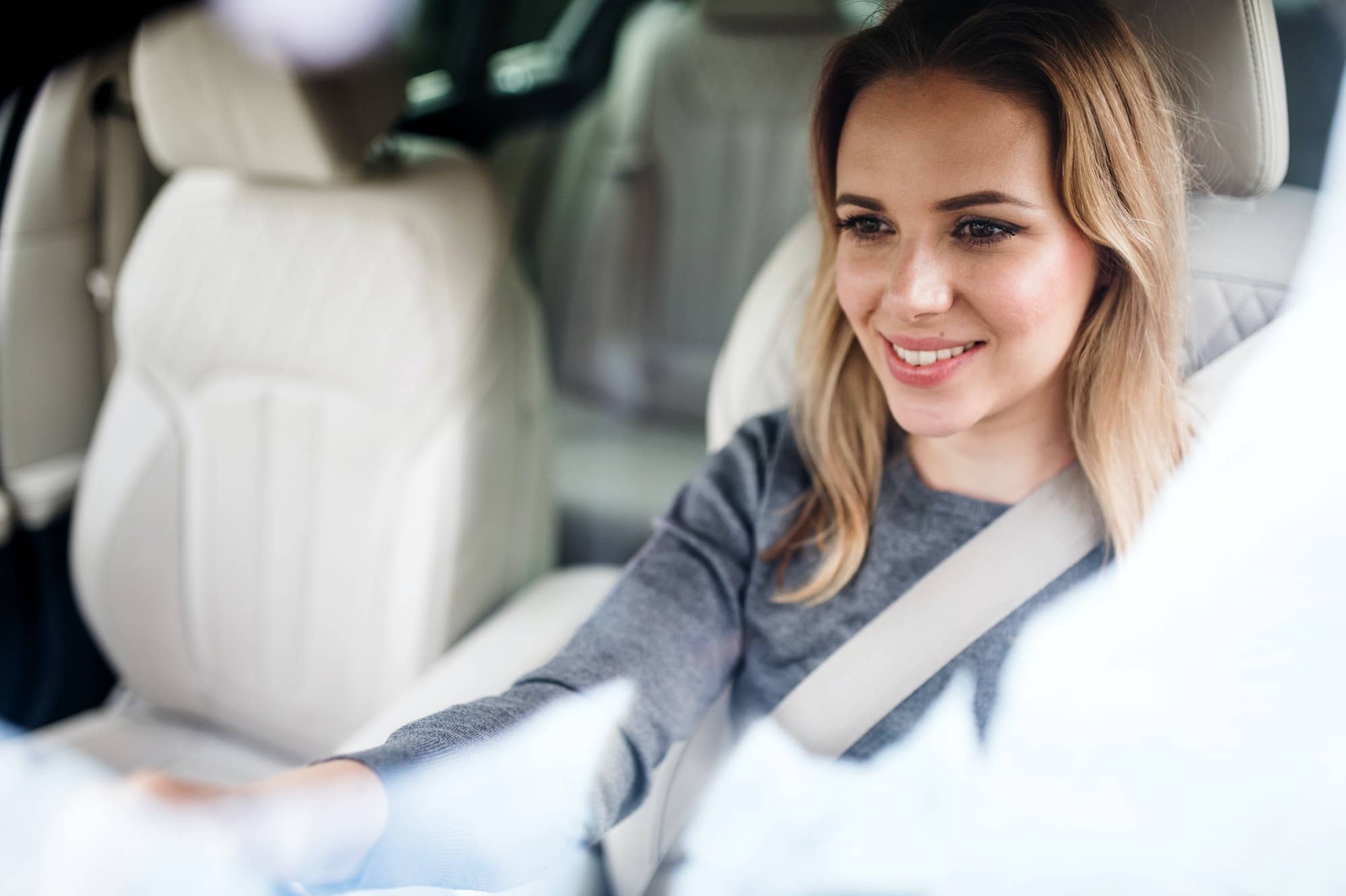 young-woman-driver-sitting-in-car-driving.jpg